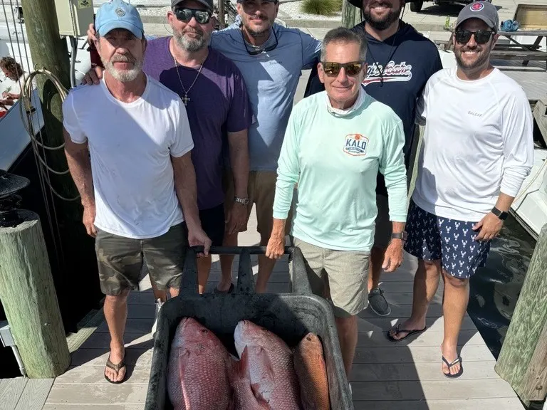 Five men on the dock in Boca Grande with a tub of the day's catch