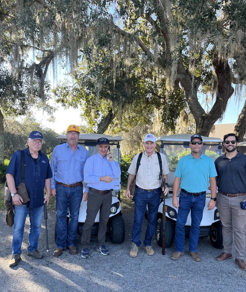 The shooters under the oaks before the round at the John R. Alexander Clays Classic