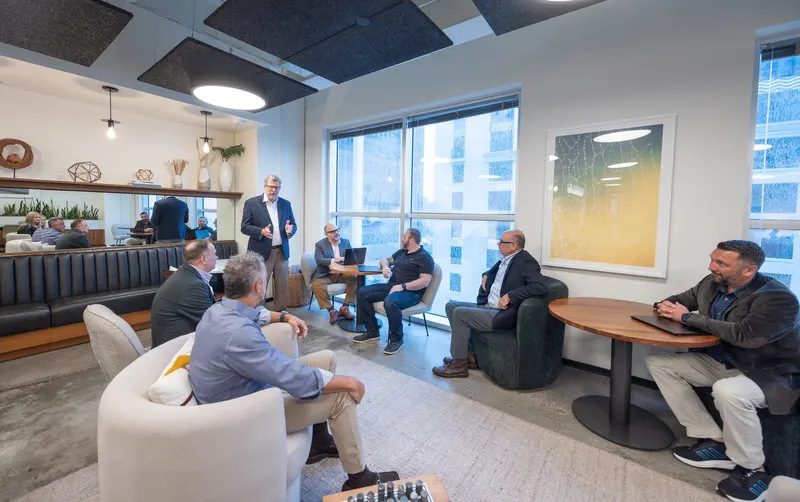 Three of the team around the round table in the lounge
